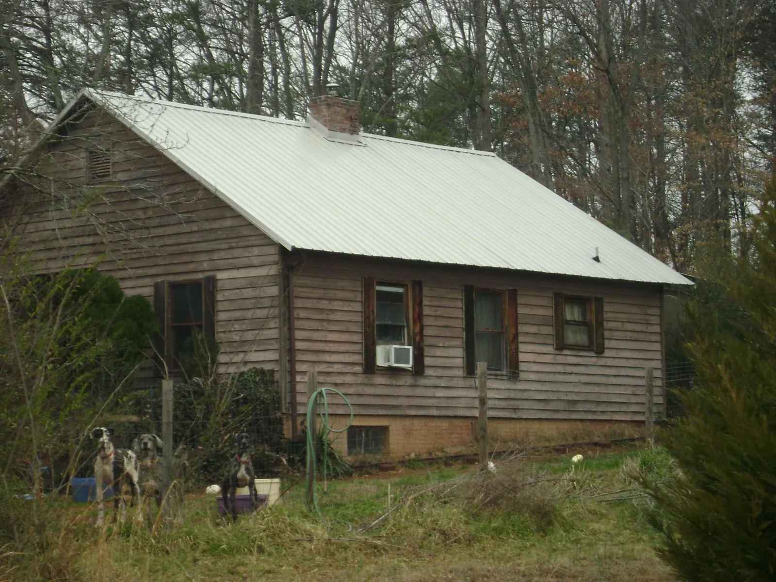 White metal roof on an old wood sided farmhouse, from a Metal Roof Installation job in Hanska